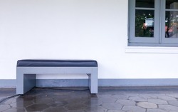 Empty bench with space wall and window