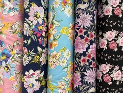 
Rolls of piles of floral patterned fabric in a fabric shop are sold in meter sizes with unique and beautiful colors. A fabric store that displays fabrics in display cases and cabinets.