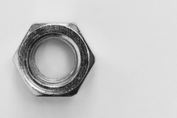 steel pentagonal nut on grey background top view with copy space, black and white photo