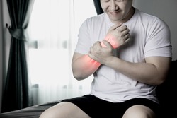 Arm muscle pain, wrist bone injury, muscle weakness due to exercise. red inflamed zone Man with wrist pain after waking up in morning