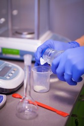 Scientist preparing a chemical solution for analysis using accurate laboratory equipment