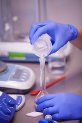 Scientist preparing a chemical solution for analysis using accurate laboratory equipment