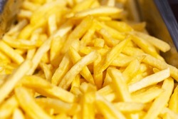 Fresh appetizing fried french fries. Ruddy stripes. Close-up. Selective focus