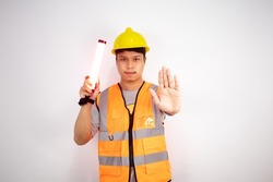 Construction workers give a stop signal by a lightstick in work clothes and a safety helmet isolated on white background.