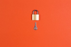 Lock and key on orange background