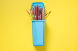 Containers for separate collection garbage with plastic straw. Top view. Concept save planet.