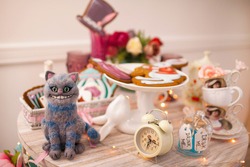The Cheshire Cat, 
a character based on the Lewis Carroll fairy tale Alice in Wonderland.  Mad tea party.