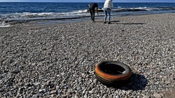 A car tire dumped on the beach.