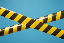 Black and yellow lines of barrier tape forbids passage. Concept of No entry. Protection from coronavirus.