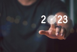 Man Finger pressing on start year 2023 button on virtual interface with copy space for text. Concept of new year. Beginning of New Year 2023. Year 2023 goal and target.