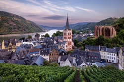 Bacharach, Germany, 07 23 2022, medieval village. City panorama from the hill covered by vineyard, Rhine Valley, Germany.