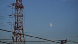 Moon in the daytime.Japanese landscape. Steel tower and daylight moon.