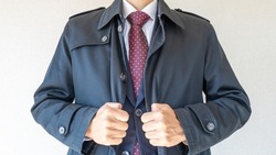 A businessman wearing a coat.