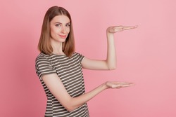 Portrait of pretty promoter blonde lady hands measure object empty space on pink background