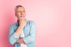 Photo of mature man arm touch chin windered think look empty space plan isolated over pink color background