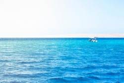 Landscape with boat, sea, bright sun and blue sky