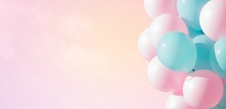 Beautiful panoramic background with pink and blue balloons. Group of pastel party balloons on soft background. Concept of happiness, joy, birthday. Wide Angle Holiday Web Banner With Copy Space