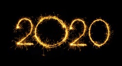 Happy New Year 2020. Number 2020 written sparkling sparklers isolated on black background With Copy Space For Text. Beautiful Glowing overlay template for holiday greeting card.