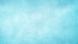 Beautiful Abstract Grunge Decorative Light Blue Cyan Painted Stucco Wall Texture. Handmade Rough Winter Christmas Paper Wide Background With Copy Space