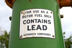 Sign on old fuel tank. For use as a motor fuel only. Contains lead. Antiknock compounds. Octane rating booster.