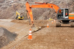 Construction site: Backhoe making banked slope