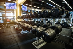 Rows of Dumbbells and Fitness Equipment in Gym - Sport and Health Care Concept