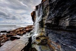 Waterfall landscape and seascape on the southern British coast