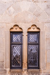 These two beautiful elongated stained glass windows are surrounded by an ornate stone pattern. They are medieval castle windows. Burg Bentheim in Bad Bentheim,  Germany.