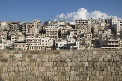 View to the slums with the walls of Citadel of Raymond de Saint-Gilles with cloud, Tripoli, Lebanon