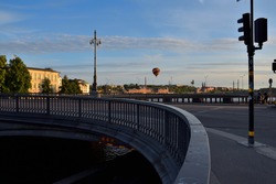 View of the evening sky above stockholm's bridges. Where some ballons flying through the blue sky.
