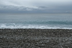 Stony beach with overcast sky in Nice, France