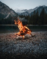Isolated campfire in nature. campfire in nature with river and forest view. campfire with fire blazing for wallpaper, background