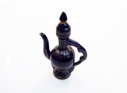 Old blue ceramic teapot on white background