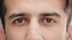 slow motion of male eye close up from young man