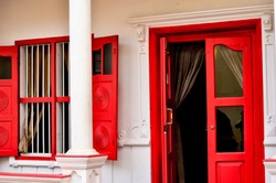Open Red Door and windows on a colonial house in Fort Kochi (Cochin), Goa, Pondicherry India