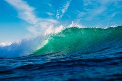 Turquoise waves in ocean. Breaking wave with sun light