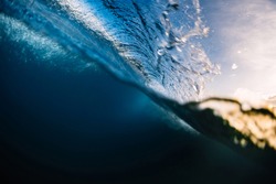 Crashing surfing wave in ocean with warm tones at sunrise or sunset. Split shot