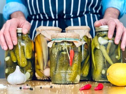 Artisanal. A man is doing pickles jars stock for winter season. Organic homemade cucumber pickles
