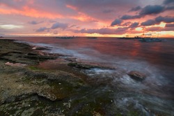 Sunset over rocky coast of Apo island, Philippines