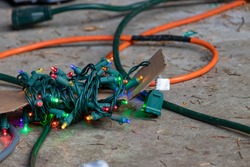 lights and orange extention cord laying on ground outside