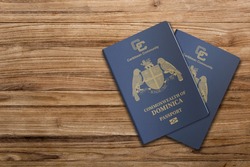 The Dominica passport is issued to citizens of the Commonwealth of Dominica for international travel,Dominica passport on a wooden background
