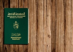 Tunisian passport on wooden background ,the Tunisian passport is issued to citizens of Tunisia for international travel.