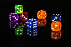 Colourful dices with reflection on black background