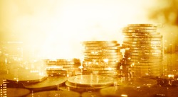 Double exposure of city and stack of coins for finance and banking concept