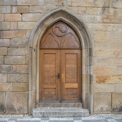 old wooden door in wall - charles bridge, prague