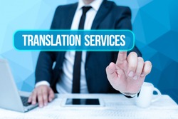 Text showing inspiration Translation Services. Word Written on organization that provide showing to translate speech Bussiness Man Sitting Desk Laptop And Phone Pointing Futuristic Technology.