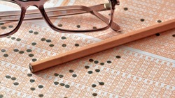 Optical reader, pen and glasses. Exam idea. Selective focus.