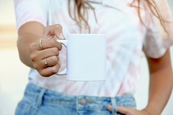 Woman holding white coffee mug.  white porcelain mug mock up 