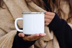 Enamel White Mug with Gray Borderline Mock-up. Girl in camping clothes holding white old tin campfire cup. Camping mug mock up.