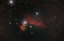 flame and horse head nebula in the orion constellation surrounded by h alpha dust in deep space taken with modified dslr camera